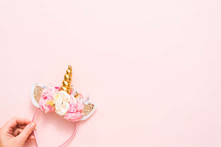 Unicorn headband with flowers and gold horn on blue background.の写真素材