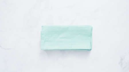 New linen dinner napkin on marble countertop.の写真素材