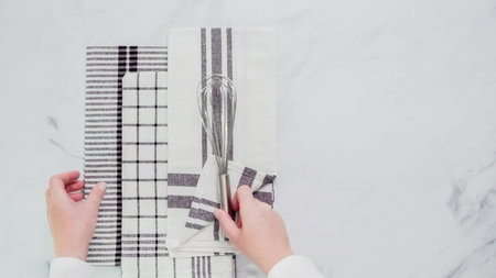Folding Blck and white patterned paper towels on marble surface.