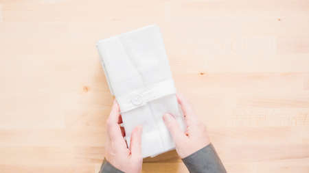 New linen dinner napkin on wood table.の写真素材