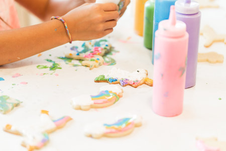 Little girls making unicorn cookies at the play date.
