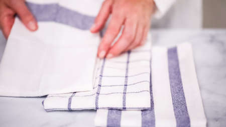 Folding blue and white patterned paper towels on marble surface.の写真素材