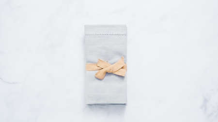 New linen dinner napkin on marble countertop.の写真素材