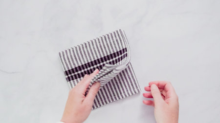 Folding Blck and white patterned paper towels on marble surface.の写真素材
