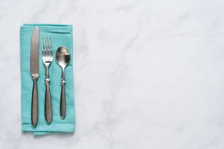 Set of dining silverware on linen dinner napkin.の写真素材