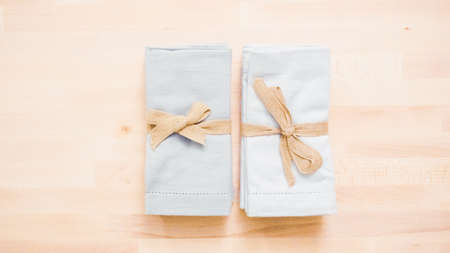 New linen dinner napkin on wood table.の写真素材