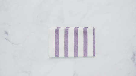 Folding blue and white patterned paper towels on marble surface.の写真素材