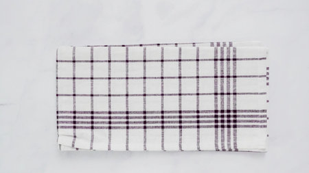 Folding Blck and white patterned paper towels on marble surface.