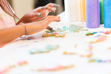Little girls making unicorn cookies at the play date.の写真素材