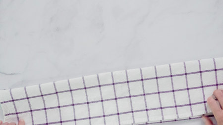 Folding Blck and white patterned paper towels on marble surface.