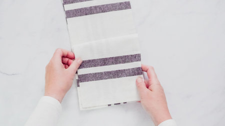 Folding Blck and white patterned paper towels on marble surface.の写真素材