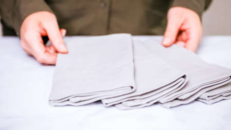 New linen dinner napkin on marble countertop.の写真素材