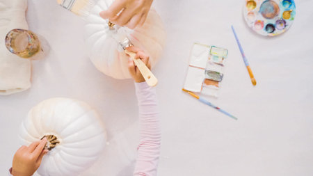 Step by step. Decorating Halloween craft pumpkin with unicorn theme.
