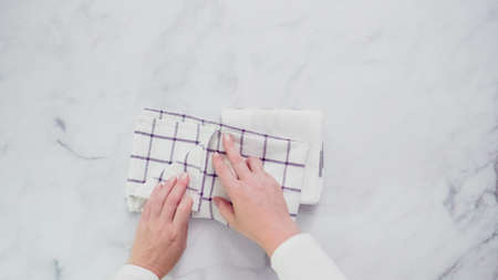 Folding blue and white patterned paper towels on marble surface.の写真素材
