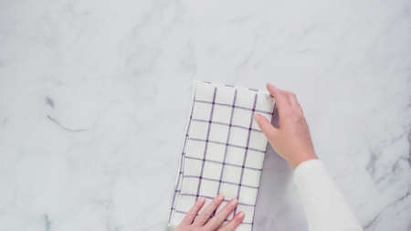 Folding blue and white patterned paper towels on marble surface.の写真素材