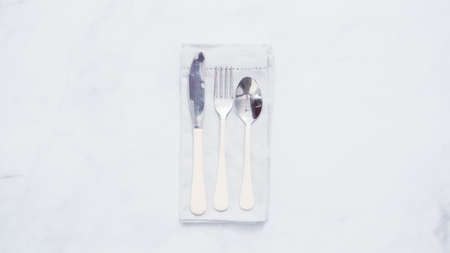 Dinner silverware on linen dinner napkin.の写真素材