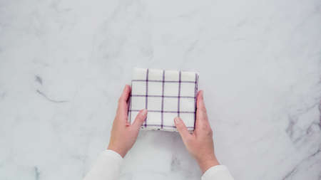Folding blue and white patterned paper towels on marble surface.の写真素材