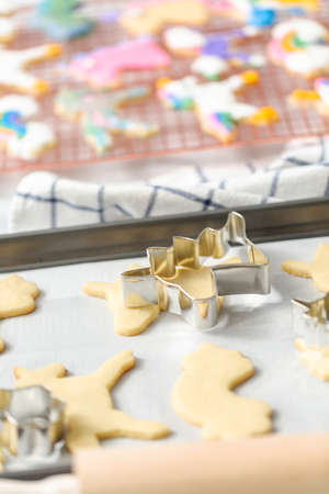 Unfinished unicorn shape sugar cookies on the baking sheet.の写真素材