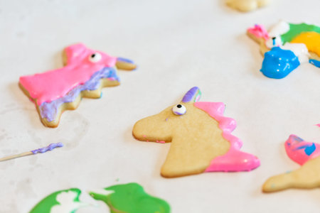 Little girls making unicorn cookies at the play date.