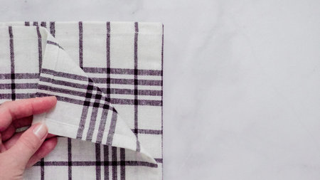 Folding Blck and white patterned paper towels on marble surface.