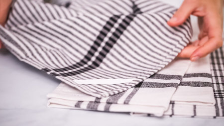 Folding Blck and white patterned paper towels on marble surface.の写真素材