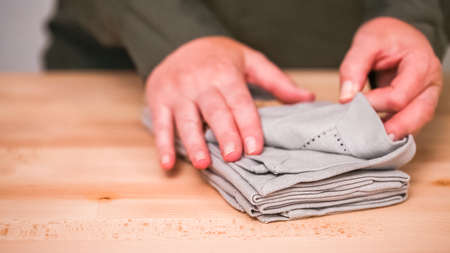 New linen dinner napkin on wood table.の写真素材