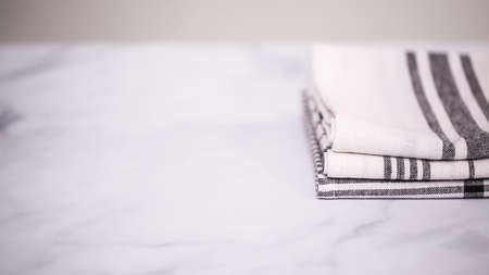 Folding Blck and white patterned paper towels on marble surface.の写真素材