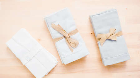 New linen dinner napkin on wood table.の写真素材