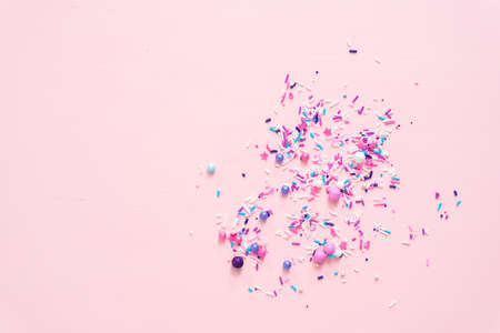 Colorful purple sprinkle blend on a pink background.の写真素材