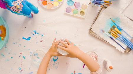 Step by step. Decorating painted paper mache unicorn with paper flowers and jewels.