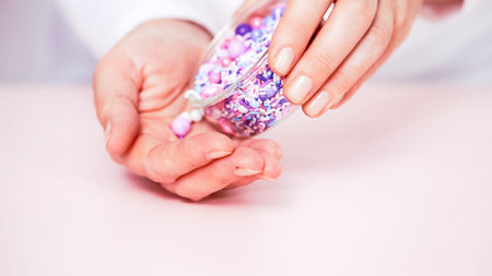 Colorful purple sprinkle blend on a pink background.の写真素材