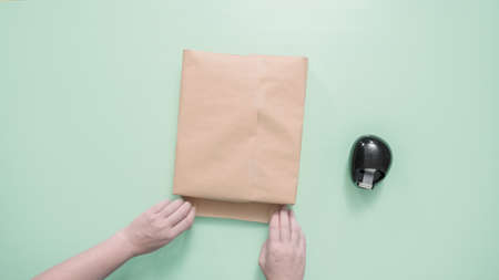 Wrapping kids present in brown paper.の写真素材