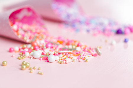 Colorful pink and purple sprinkle blends on a pink background.