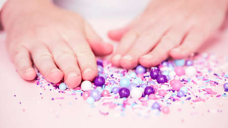 Colorful purple sprinkle blend on a pink background.の写真素材