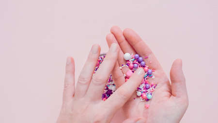 Colorful purple sprinkle blend on a pink background.の写真素材