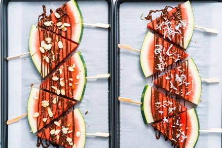 Watermelon drizzled with chocolate and topped with flaked sea salt and almonds.の写真素材