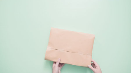 Wrapping kids present in brown paper.