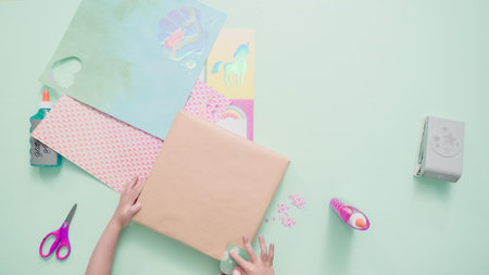 Decorating present for kids birthday with craft paper.