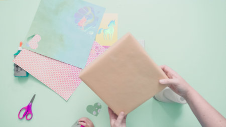 Decorating present for kids birthday with craft paper.