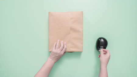 Wrapping kids present in brown paper.