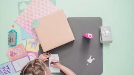Decorating present for kids birthday with craft paper.