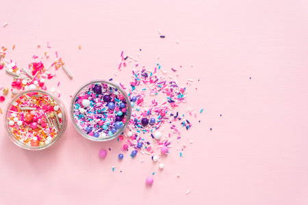 Colorful pink and purple sprinkle blends on a pink background.