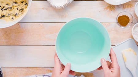 Mixing ingredients together in mixing bowl for blueberry muffins.の写真素材