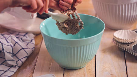 Mixing ingredients together in mixing bowl for blueberry muffins.の写真素材