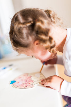 Little girl drawing at her desk at home.の写真素材