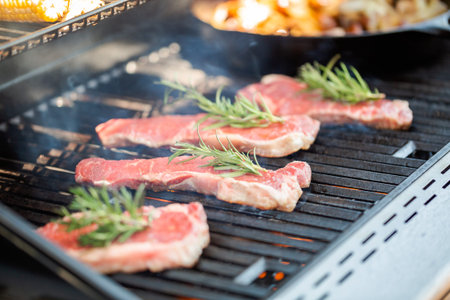 Step by step. Grilling New York strip steak on outdoor gas grill.