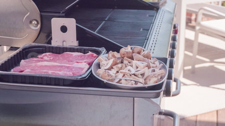 Step by step. Raw New York strip steak ready for outdoor grilling.