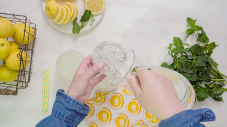 Step by step. Pouring traditional fresh lemonade in glasses.の写真素材