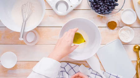 Mixing ingredients together in mixing bowl for blueberry muffins.の写真素材