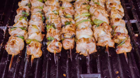 Step by step. Glazing chicken yakitori on bamboo skewers with pastry brush.の写真素材